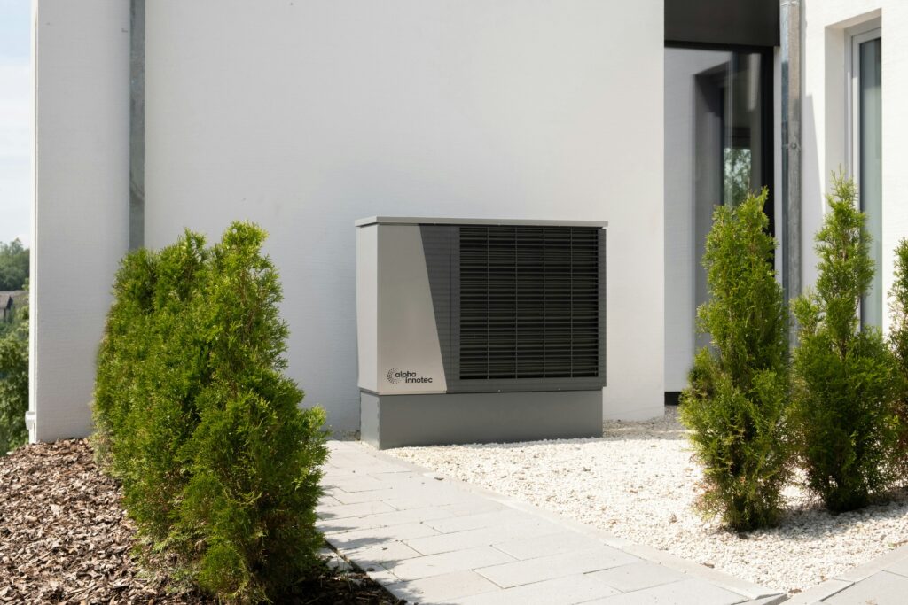 An air source heat pump unit positioned outside a house